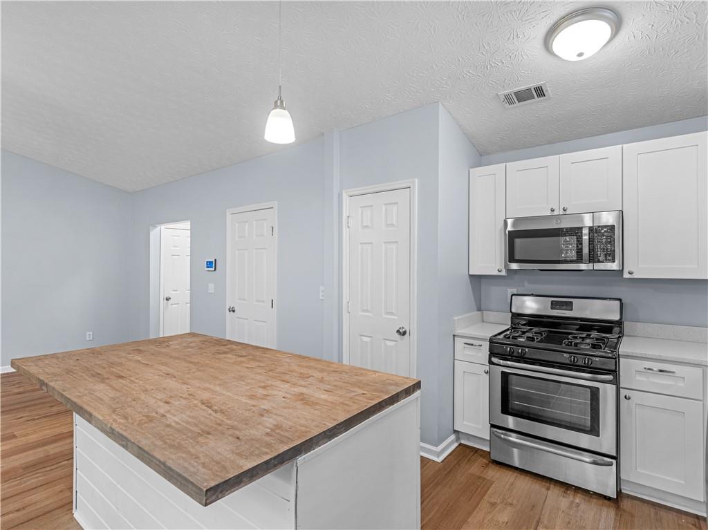 1540 Foxhall Lane Atlanta, GA 30316 - Photo 11 of 25 a kitchen with granite countertop a sink cabinets and stainless steel appliances