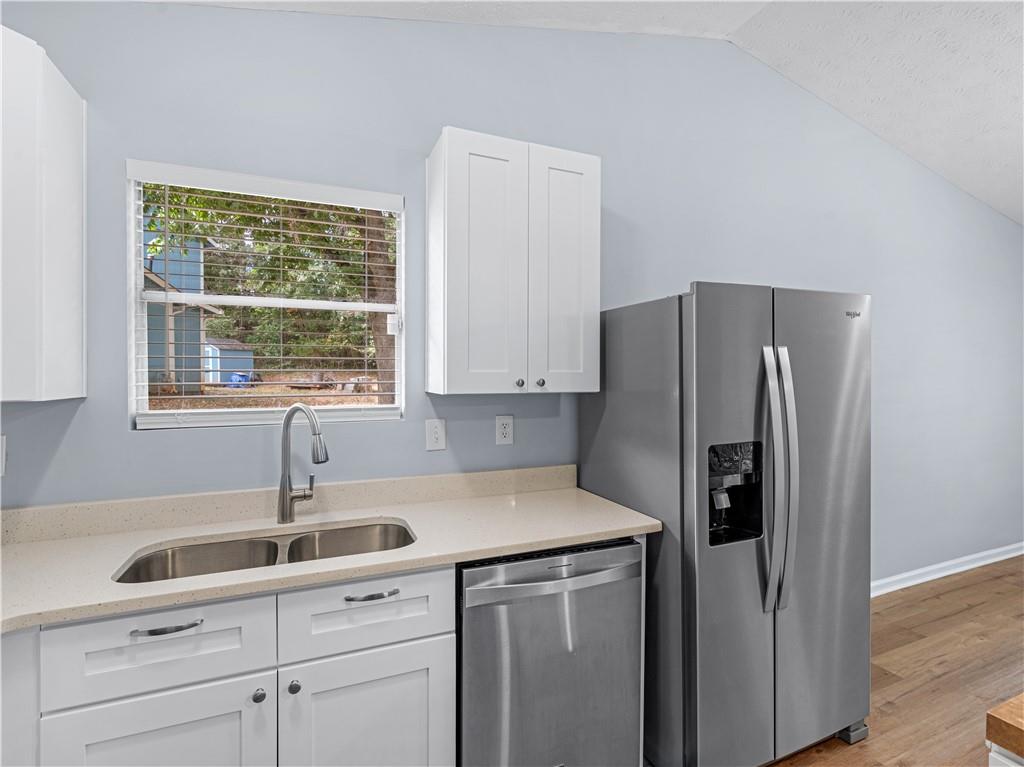 1540 Foxhall Lane Atlanta, GA 30316 - Photo 13 of 25 a kitchen with a refrigerator sink and cabinets