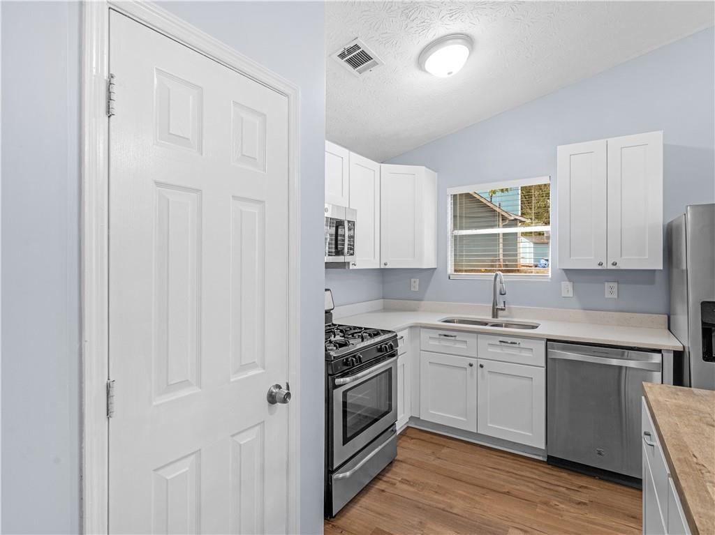 1540 Foxhall Lane Atlanta, GA 30316 - Photo 16 of 25 a kitchen with white cabinets and white appliances