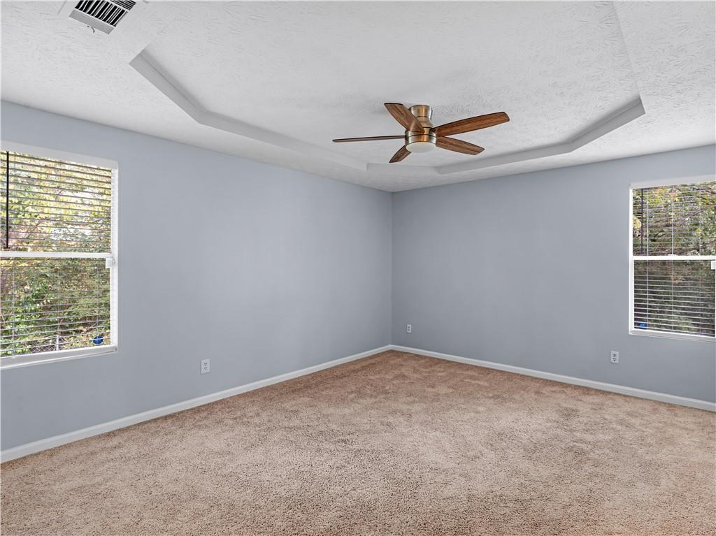 1540 Foxhall Lane Atlanta, GA 30316 - Photo 21 of 25 an empty room with windows and ceiling fan
