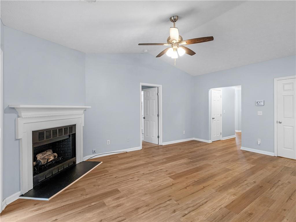 1540 Foxhall Lane Atlanta, GA 30316 - Photo 5 of 25 a view of empty room with wooden floor and fireplace