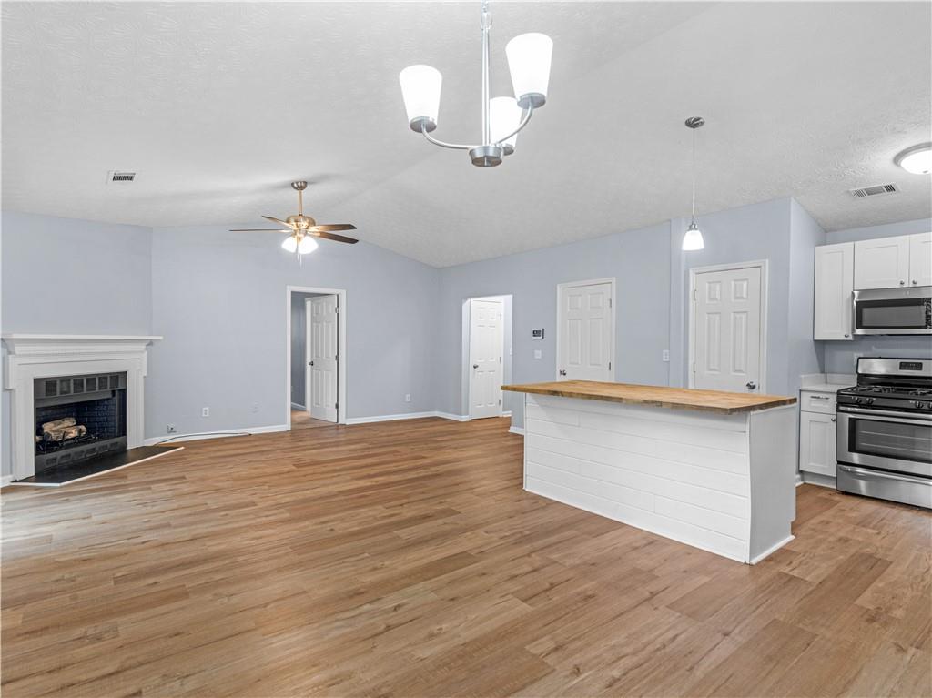 1540 Foxhall Lane Atlanta, GA 30316 - Photo 9 of 25 a view of an empty room with kitchen and a fireplace