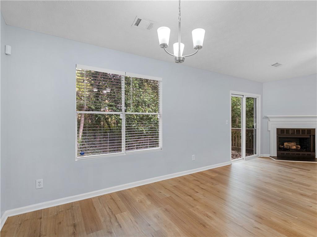 1540 Foxhall Lane Atlanta, GA 30316 - Photo 10 of 25 a view of an empty room with wooden floor fireplace and a window