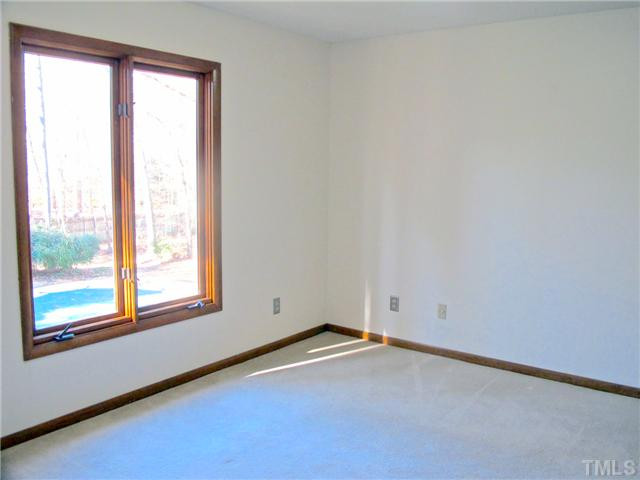 8521 Kempton Road Raleigh, NC 27615 - Photo 16 of 25 Upstairs bedroom overlooks the pool area. Bedroom