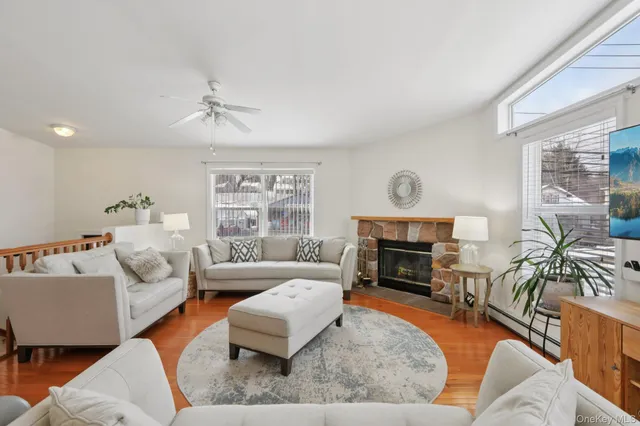a living room with furniture fireplace and a large window