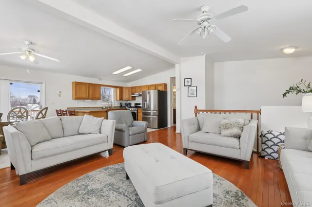 a living room with furniture and view of kitchen