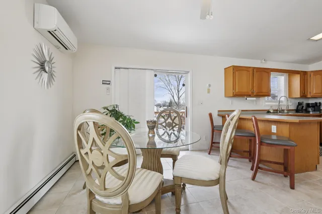 a view of a dining room with furniture and a window