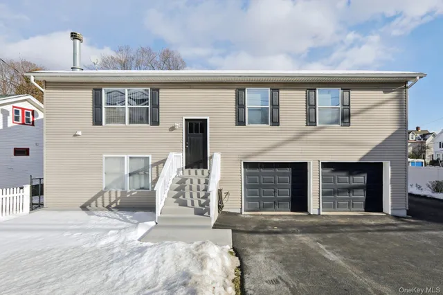 a front view of a house with a yard and a garage