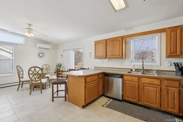 a kitchen with a sink table and chairs
