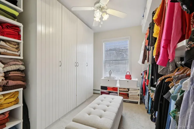 a view of walk in closet with clothes and shoes