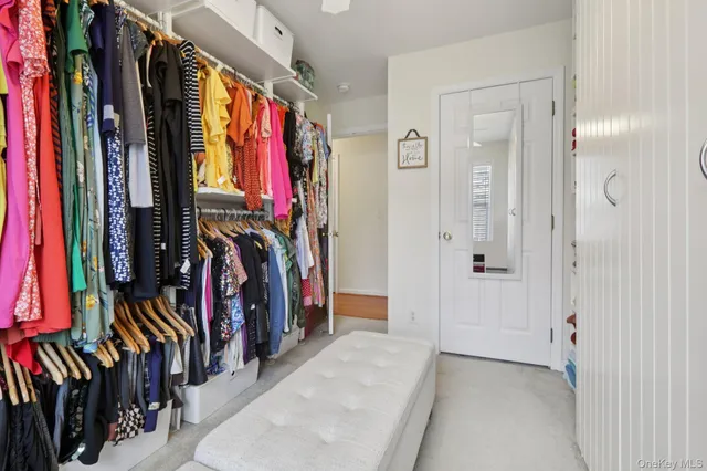 a view of walk in closet with clothes