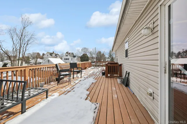a view of balcony with wooden floor and fence