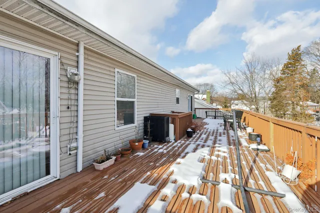 a view of a balcony with wooden floor and fence