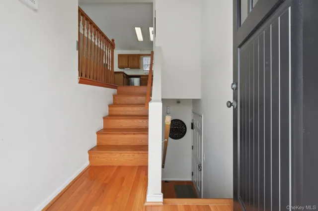 a view of a hallway with wooden floor and entryway