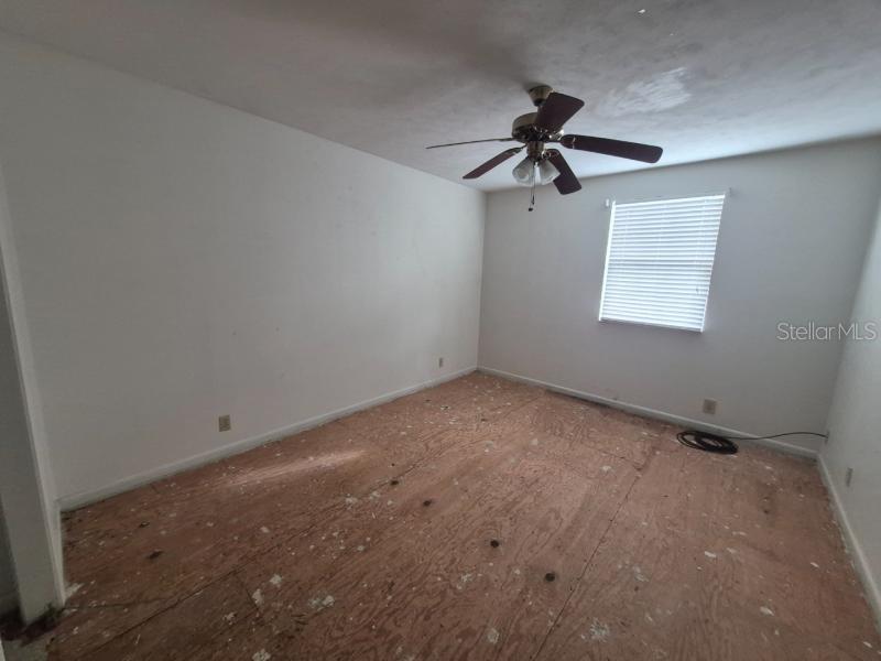 1702 Ketch Place Brandon, FL 33511 - Photo 12 of 14 an empty room with windows and fan