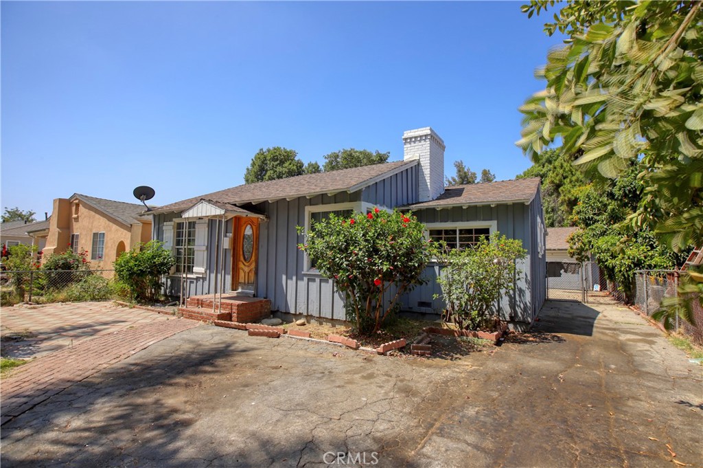 7339 Baird Avenue Reseda, CA 91335 - Photo 3 of 22 a front view of a house with a yard