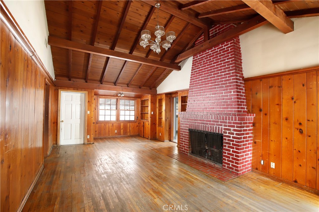 7339 Baird Avenue Reseda, CA 91335 - Photo 4 of 22 a view of a livingroom with wooden floor and a fireplace