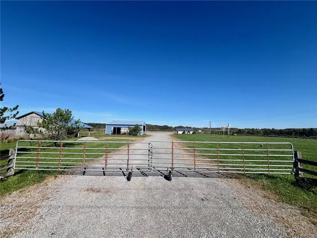 a view of a golf course with a wooden fence