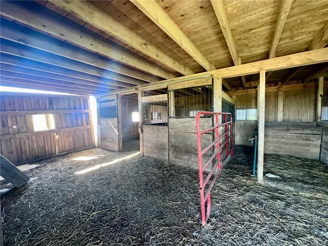 a view of a porch with furniture and a yard
