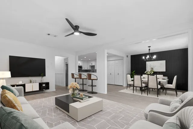 a living room with furniture a rug and a flat screen tv