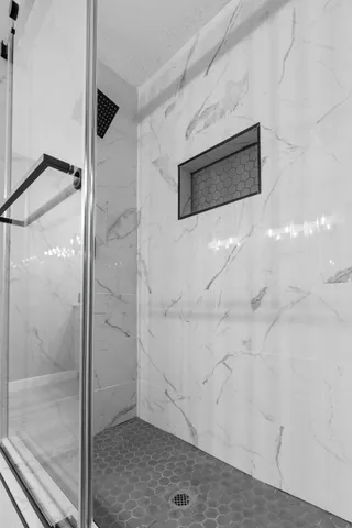 a bathroom with a shower and mirror