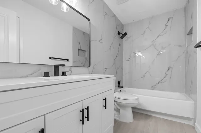 a bathroom with a sink a toilet and a bathtub