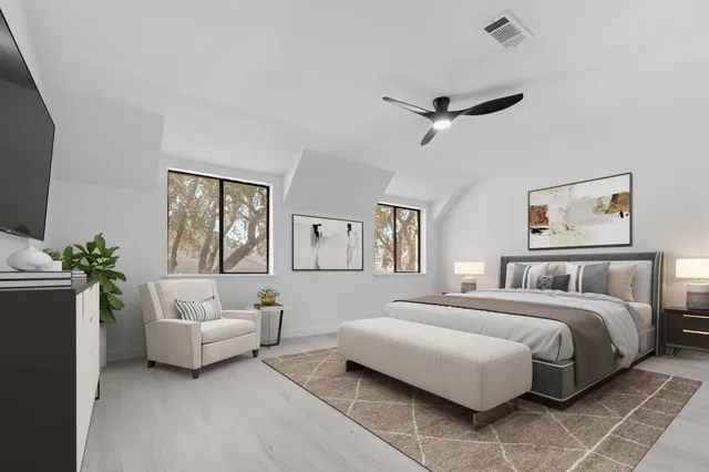 a bedroom with a bed couches and white walls