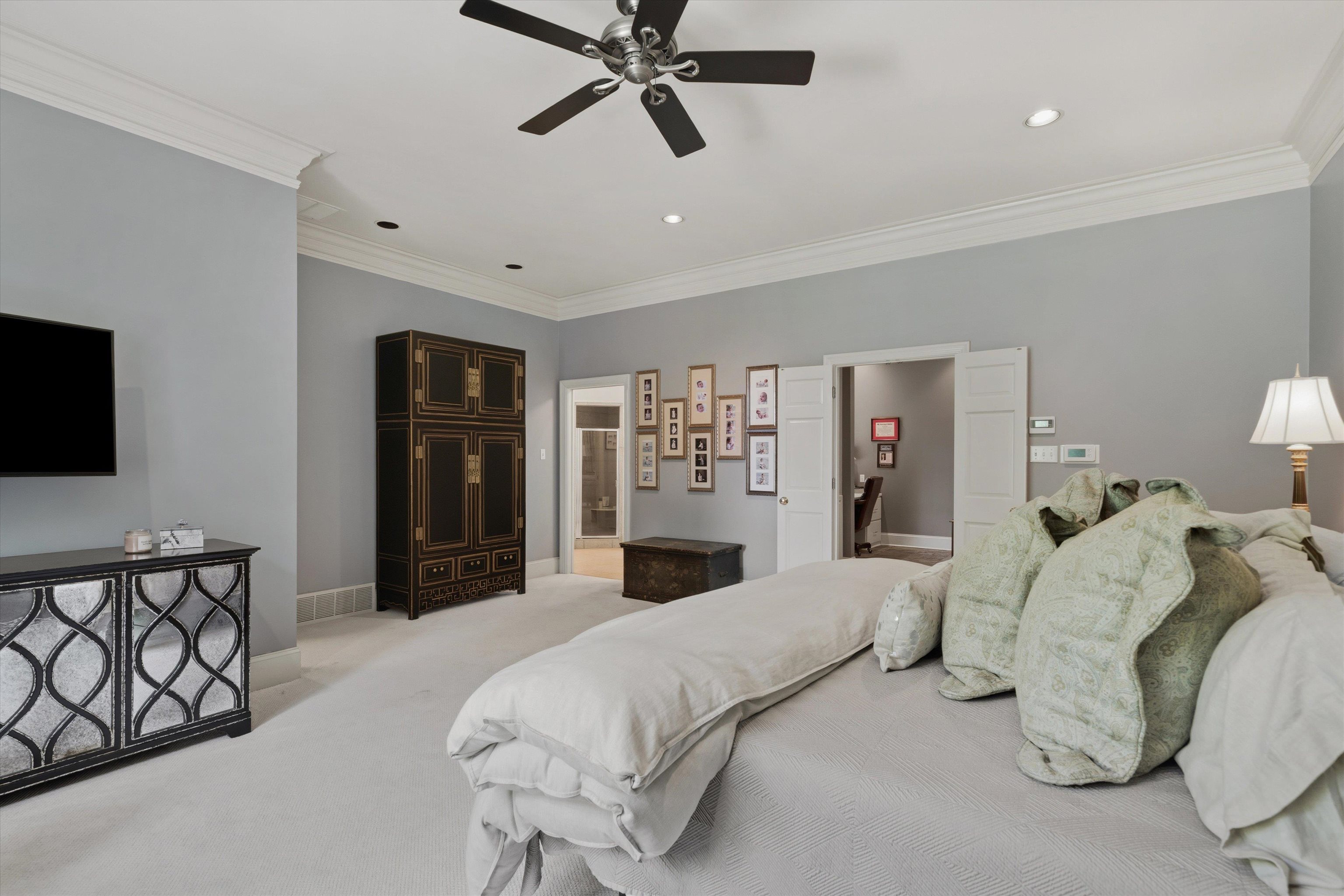 4710 Gwynne Road Memphis, TN 38117 - Photo 19 of 40 a bedroom with a large bed and a flat screen tv