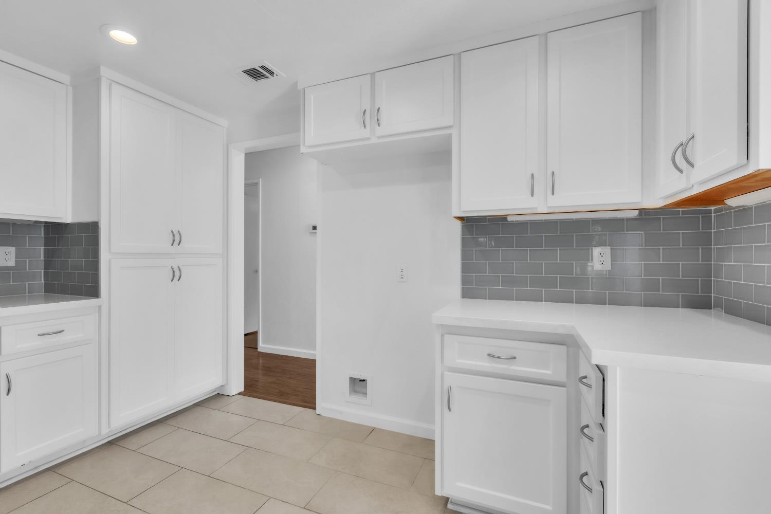 136 Rambling Drive Folsom, CA 95630 - Photo 13 of 31 a kitchen with white cabinets and a refrigerator