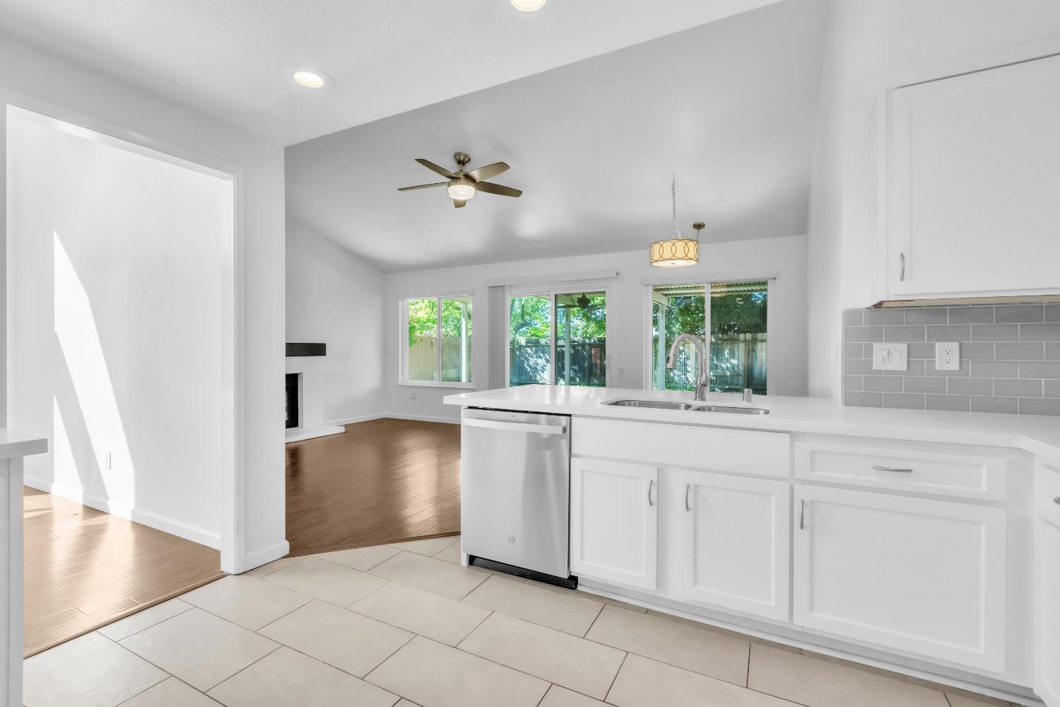 136 Rambling Drive Folsom, CA 95630 - Photo 14 of 31 a kitchen with white cabinets and window