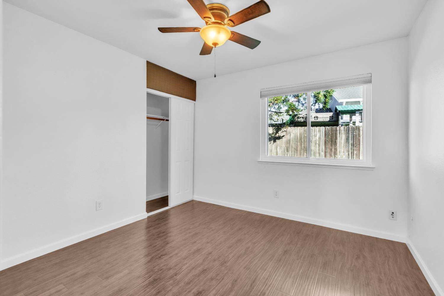 136 Rambling Drive Folsom, CA 95630 - Photo 26 of 31 an empty room with wooden floor and windows