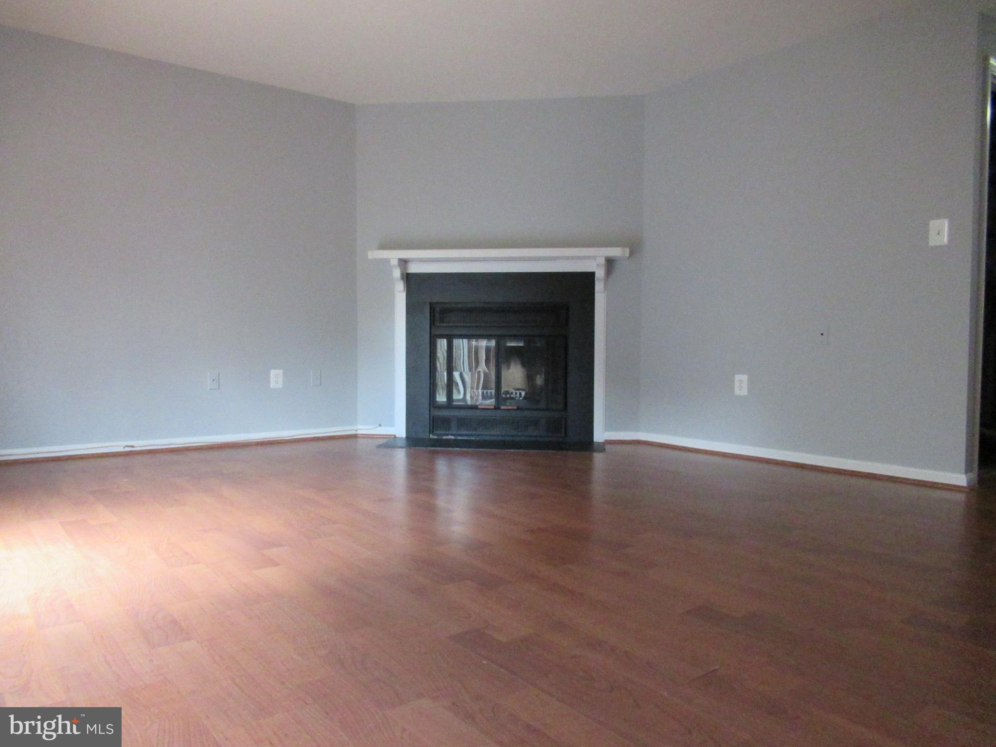 2310 Patternbond Drive Silver Spring, MD 20902 - Photo 19 of 29 a view of an empty room with a fireplace and a window