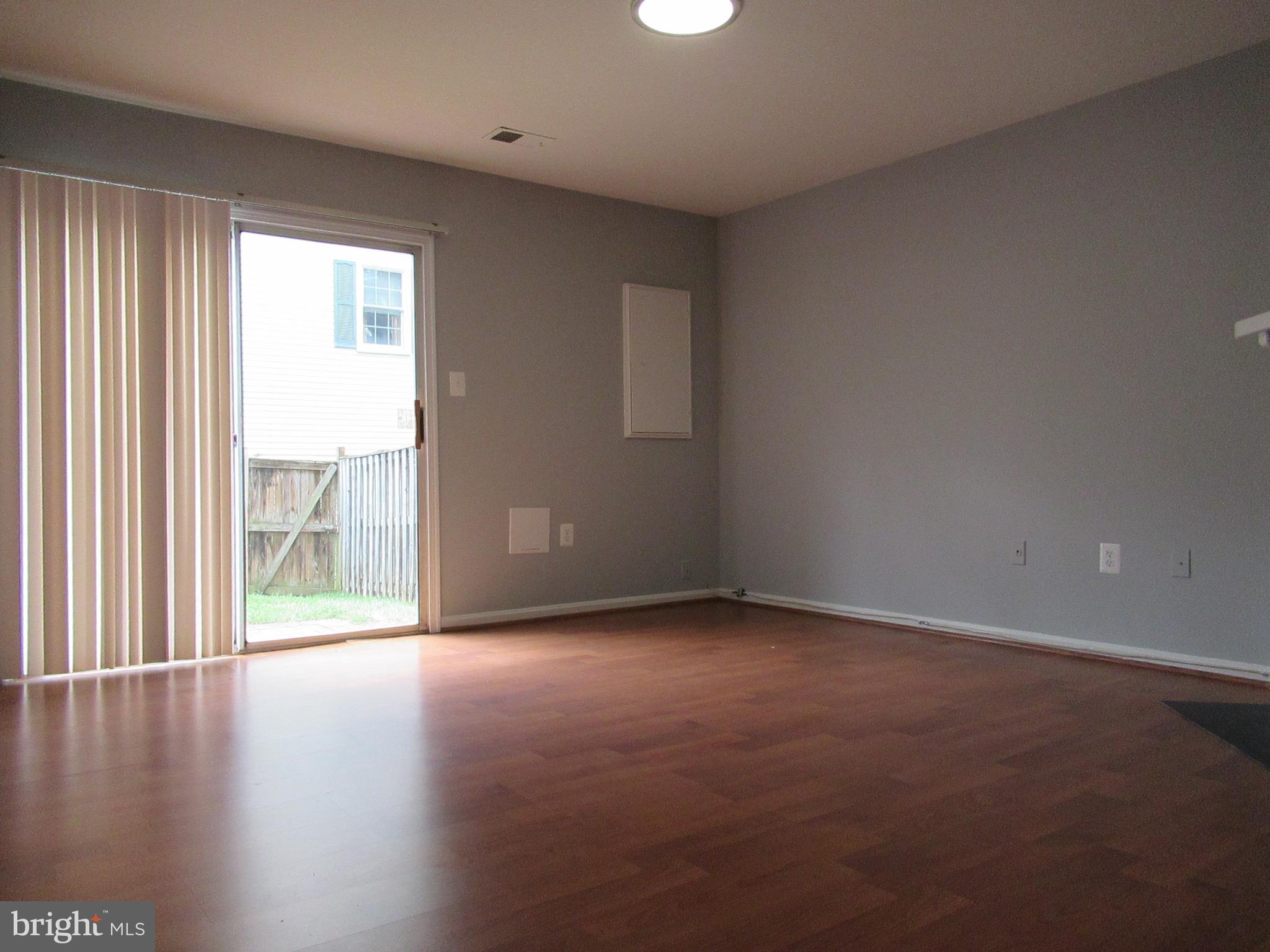 2310 Patternbond Drive Silver Spring, MD 20902 - Photo 20 of 29 an empty room with wooden floor and windows