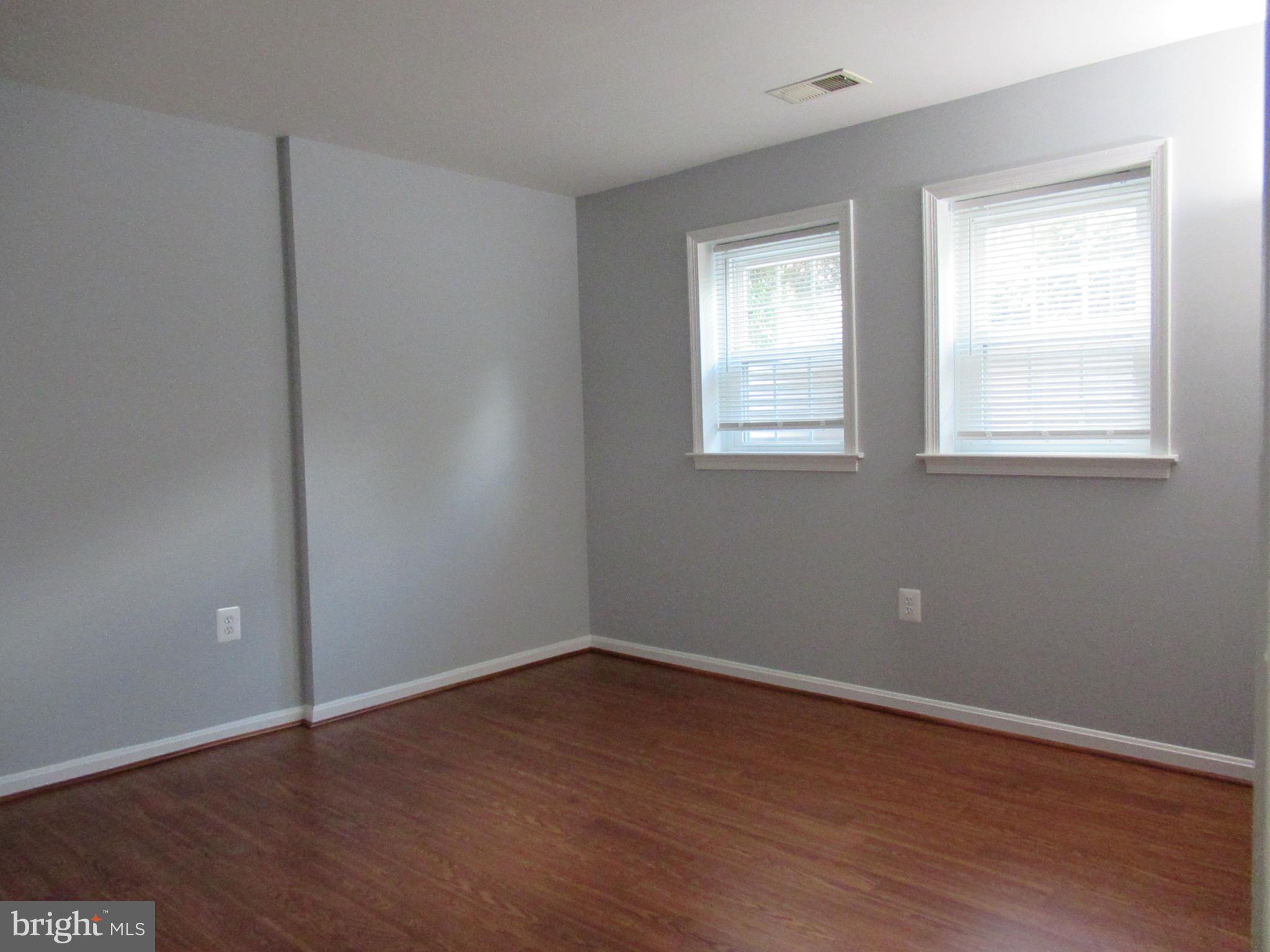 2310 Patternbond Drive Silver Spring, MD 20902 - Photo 23 of 29 an empty room with wooden floor and windows