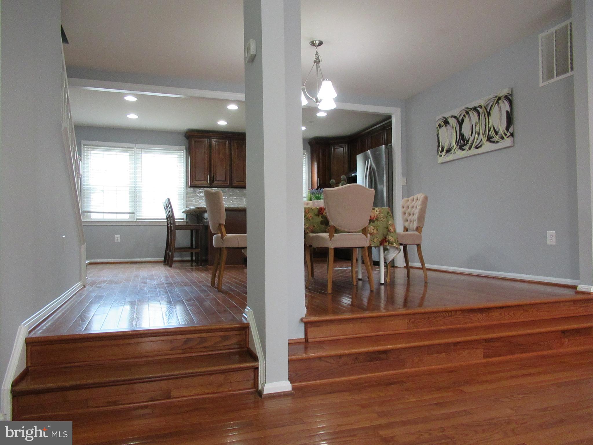 2310 Patternbond Drive Silver Spring, MD 20902 - Photo 3 of 29 a view of a dining room with furniture a chandelier and wooden floor