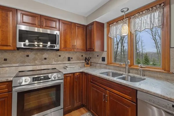 a kitchen with a sink stove and microwave