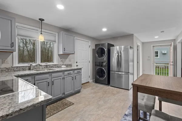 a kitchen with sink cabinets and chairs