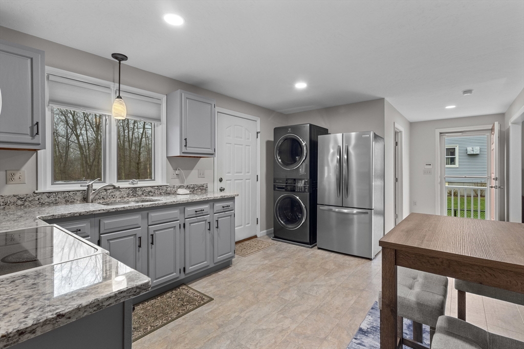 16 Flint Pond Road Worcester, MA 01604 - Photo 16 of 42 a kitchen with refrigerator and cabinets
