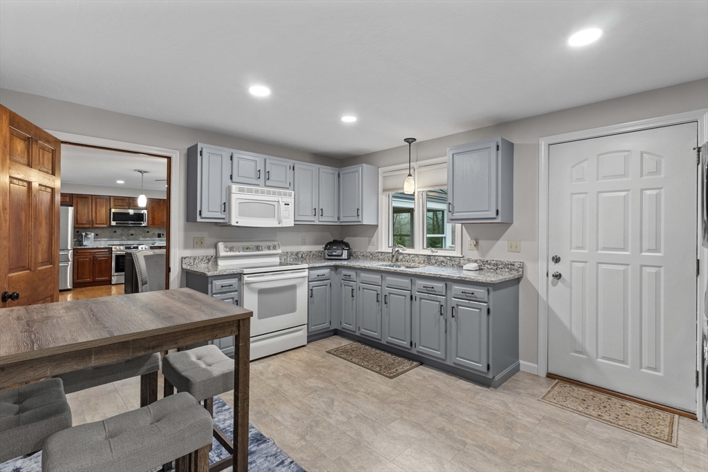 16 Flint Pond Road Worcester, MA 01604 - Photo 17 of 42 a kitchen with sink cabinets and chairs