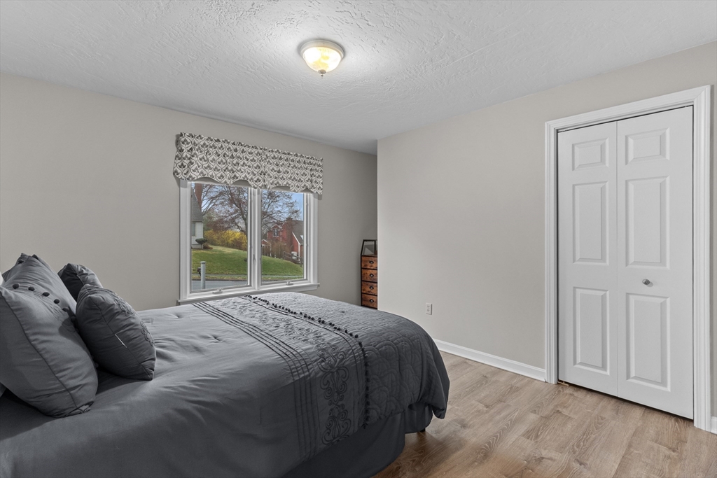 16 Flint Pond Road Worcester, MA 01604 - Photo 19 of 42 a large bed sitting in a bedroom next to a window