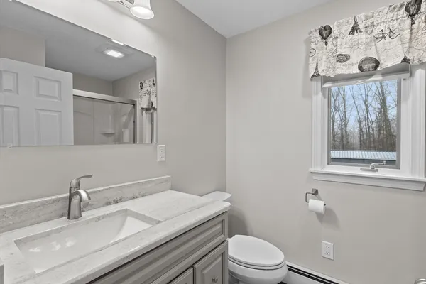 a bathroom with a glass shower door