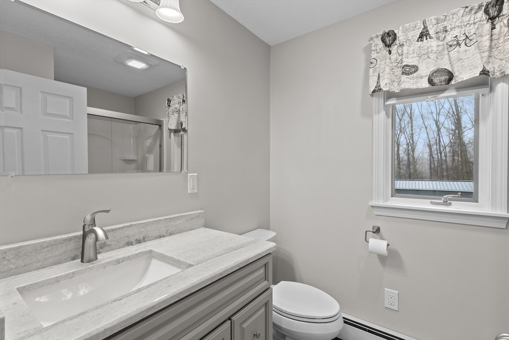 16 Flint Pond Road Worcester, MA 01604 - Photo 23 of 42 a bathroom with a granite countertop sink mirror vanity and toilet