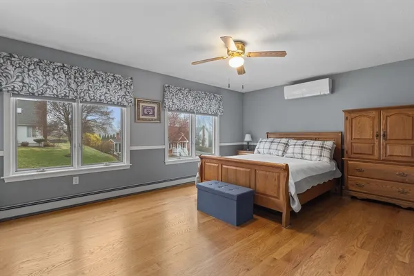 a bed room with a bed and a ceiling fan