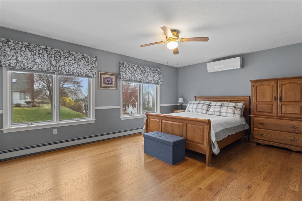 16 Flint Pond Road Worcester, MA 01604 - Photo 25 of 42 a bedroom with a large bed and a chandelier