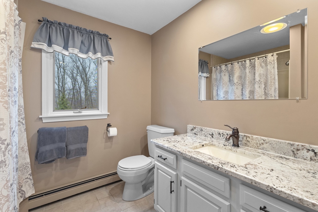 16 Flint Pond Road Worcester, MA 01604 - Photo 28 of 42 a bathroom with a granite countertop sink toilet and shower