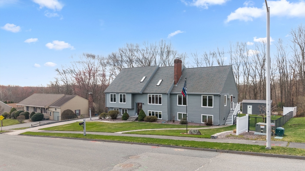 16 Flint Pond Road Worcester, MA 01604 - Photo 3 of 42 a front view of a house with a garden and trees