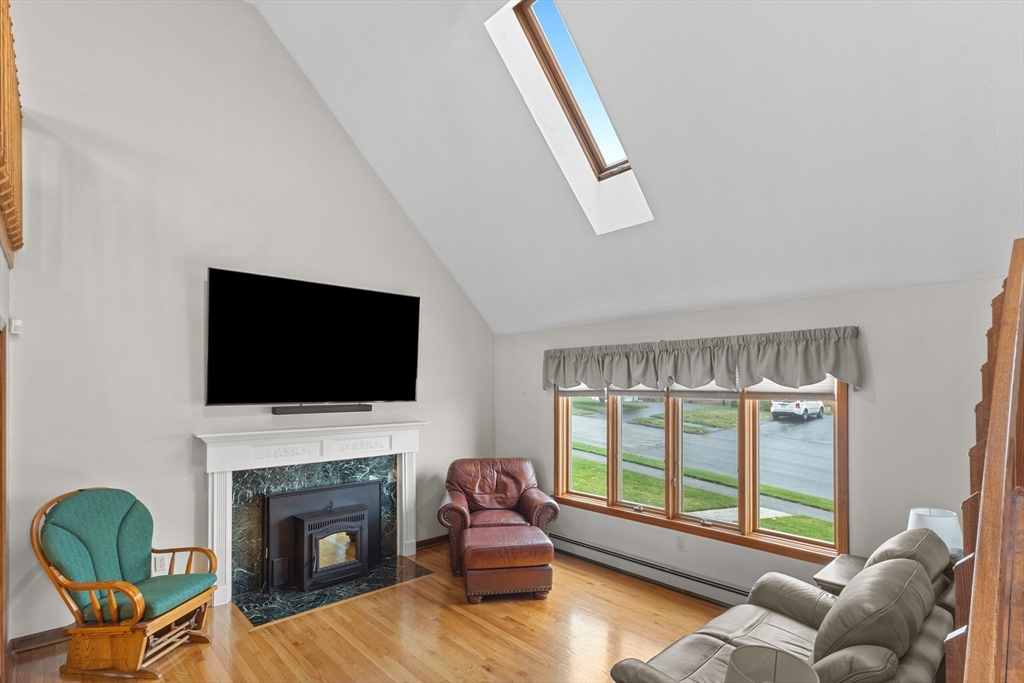 16 Flint Pond Road Worcester, MA 01604 - Photo 8 of 42 a living room with furniture a fireplace and a flat screen tv