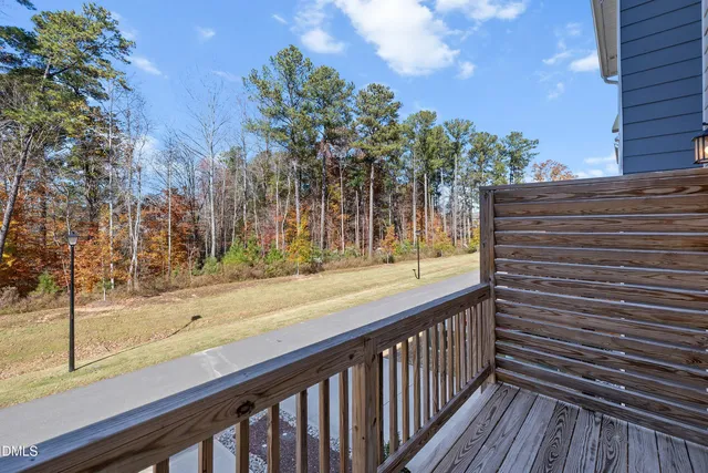 a view of a wooden fence next to a yard