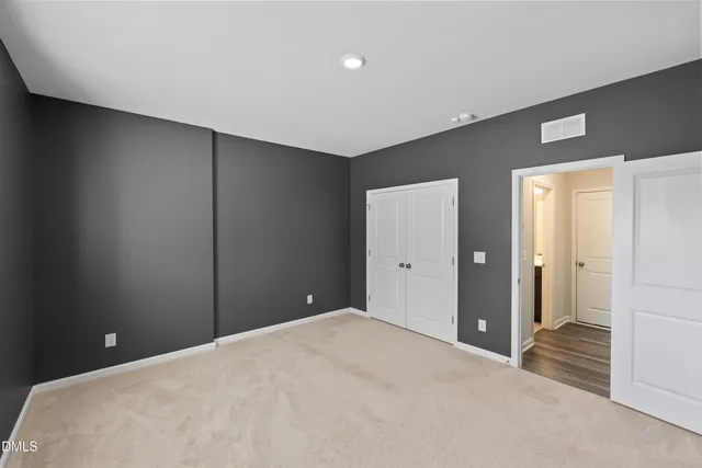 a bedroom with a bed and a view of bathroom