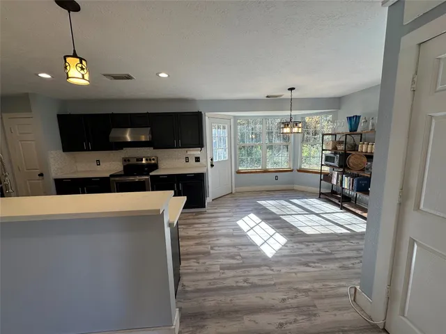 a view of a living room a window and a flat screen tv